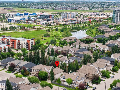 Aerial perspective of a residential neighborhood featuring detached homes with shingled roofs and established landscaping - 1110 Armitage Crescent, Edmonton, AB 