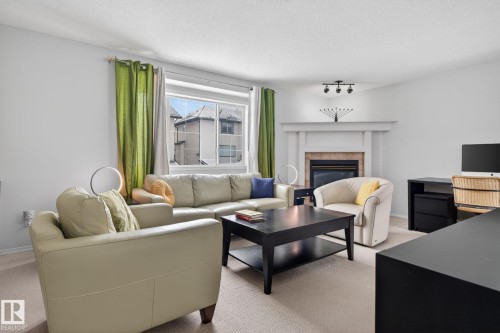 27 225 Blackburn Drive E, Edmonton, AB - Indoor Photo Showing Living Room With Fireplace