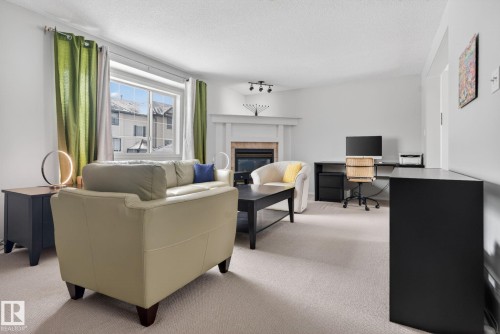 27 225 Blackburn Drive E, Edmonton, AB - Indoor Photo Showing Living Room With Fireplace