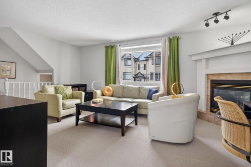 27 225 Blackburn Drive E, Edmonton, AB - Indoor Photo Showing Living Room With Fireplace