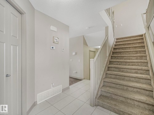 Entryway featuring a carpeted staircase and tile flooring - 21851 80 Avenue, Edmonton, AB - Indoor Photo Showing Other Room