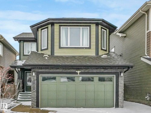 Two-story residence featuring light green siding and dark trim accents - 21851 80 Avenue, Edmonton, AB - Outdoor With Exterior
