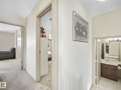 Hallway featuring light-toned carpeting and neutral wall paint - 21851 80 Avenue, Edmonton, AB - Indoor Photo Showing Other Room
