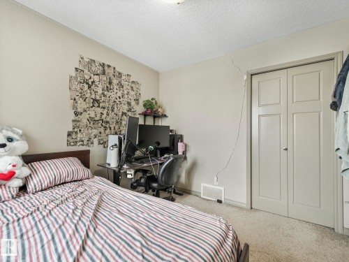 Neutral-toned walls complement the textured ceiling - 21851 80 Avenue, Edmonton, AB - Indoor Photo Showing Bedroom