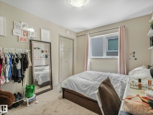 Bedroom featuring neutral-toned walls, textured ceiling, and carpet flooring - 21851 80 Avenue, Edmonton, AB - Indoor Photo Showing Bedroom