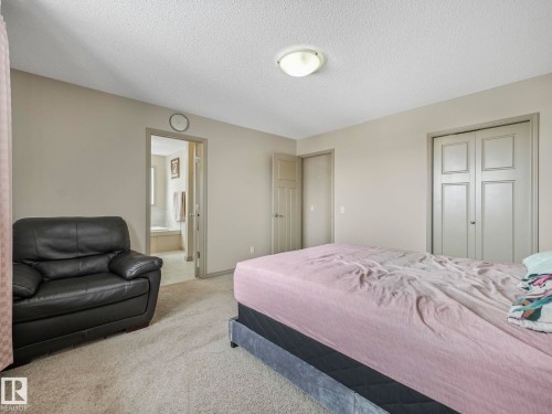 Interior room featuring neutral wall paint, textured ceiling, and carpeting - 21851 80 Avenue, Edmonton, AB - Indoor Photo Showing Bedroom