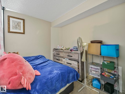 Bedroom featuring neutral wall paint, textured ceiling, and carpeted flooring - 21851 80 Avenue, Edmonton, AB - Indoor Photo Showing Bedroom