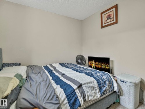 Neutral wall paint and textured ceiling in this room - 21851 80 Avenue, Edmonton, AB - Indoor Photo Showing Bedroom