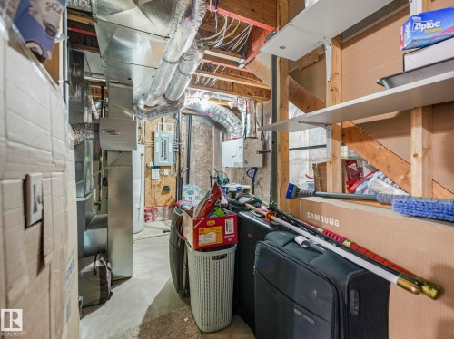 Basement utility area featuring exposed wood framing, concrete flooring, and visible ductwork - 21851 80 Avenue, Edmonton, AB - Indoor Photo Showing Basement