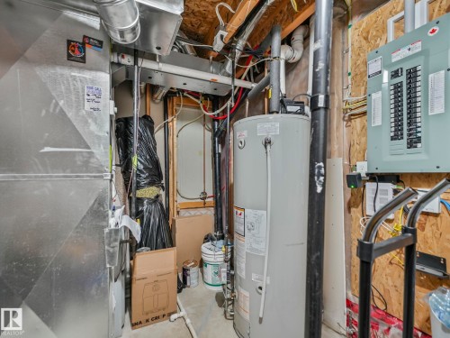 Utility space featuring a hot water heater, a furnace, and an electrical panel - 21851 80 Avenue, Edmonton, AB - Indoor Photo Showing Basement