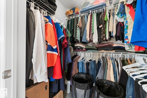 The property features a walk-in closet with white wire shelving and hanging rods - 112 Lakeland Point(E), Beaumont, AB - Indoor With Storage