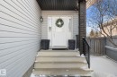 The property features a front entrance with concrete steps, a white door, and light-colored siding - 112 Lakeland Point(E), Beaumont, AB  - Outdoor With Exterior 