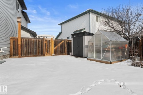 The property features a fenced yard, a greenhouse, and an outdoor storage shed - 112 Lakeland Point(E), Beaumont, AB - Outdoor With Exterior