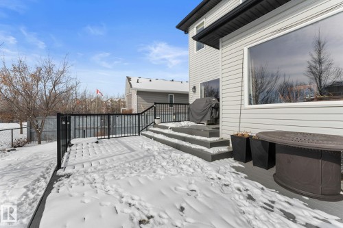 The property features a spacious deck with dark railings and steps, offering outdoor living space - 112 Lakeland Point(E), Beaumont, AB - Outdoor With Exterior