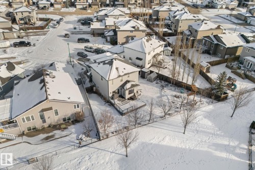 This aerial view showcases the property's exterior, including a fenced yard and a deck - 112 Lakeland Point(E), Beaumont, AB - Outdoor With View