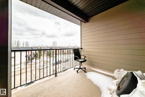 Exterior balcony featuring a black metal railing and beige horizontal siding - 404 12025 22 Avenue Sw, Edmonton, AB - Outdoor With Balcony With Exterior
