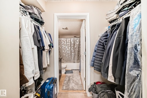 Walk-in closet featuring wire shelving and hanging rods - 404 12025 22 Avenue Sw, Edmonton, AB - Indoor With Storage
