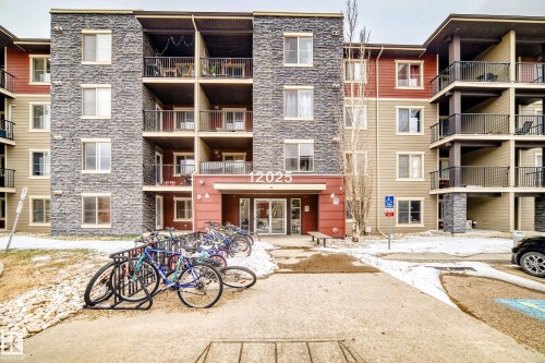 Multi-story residential building featuring stone veneer and horizontal siding - 404 12025 22 Avenue Sw, Edmonton, AB - Outdoor With Balcony With Facade