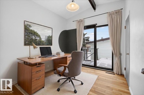 Bright room featuring wood-finish flooring and exposed ceiling beams - 6018 105A Street, Edmonton, AB 