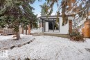 Contemporary architectural design featuring white horizontal siding and brick accents - 6018 105A Street, Edmonton, AB 