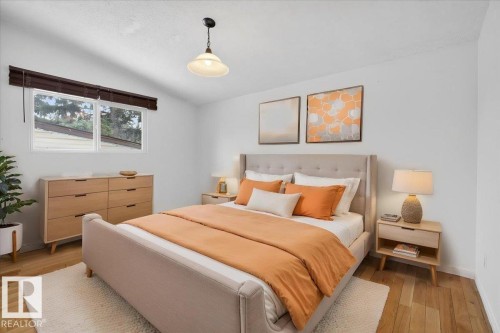 Bright room featuring wood-finish flooring, a contemporary ceiling fixture, and a window with dark wood blinds - 6018 105A Street, Edmonton, AB 