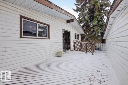 Exterior deck with a wooden railing and lattice detailing - 6018 105A Street, Edmonton, AB 