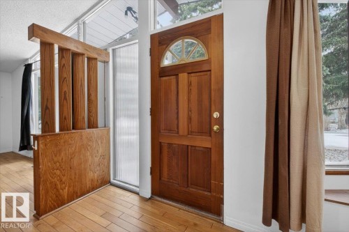 Warm wood entry door with arched transom window - 6018 105A Street, Edmonton, AB 