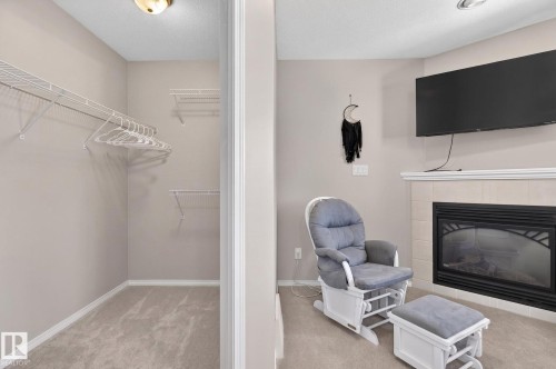 Living area featuring a gas fireplace with a tiled hearth and mantel - 1904 36 Avenue, Edmonton, AB - Indoor With Fireplace
