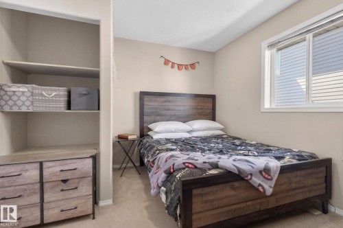 Bedroom featuring a window with blinds, light-toned walls, and neutral carpeting - 1904 36 Avenue, Edmonton, AB - Indoor Photo Showing Bedroom
