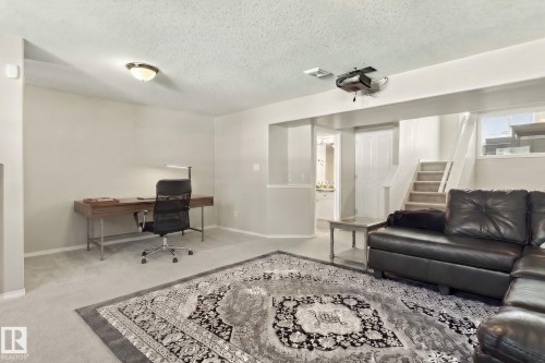 Versatile room featuring light-toned carpeting, recessed lighting, and a built-in projector - 1904 36 Avenue, Edmonton, AB - Indoor