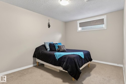 Neutral-toned walls complement the light-colored carpet flooring - 1904 36 Avenue, Edmonton, AB - Indoor Photo Showing Bedroom