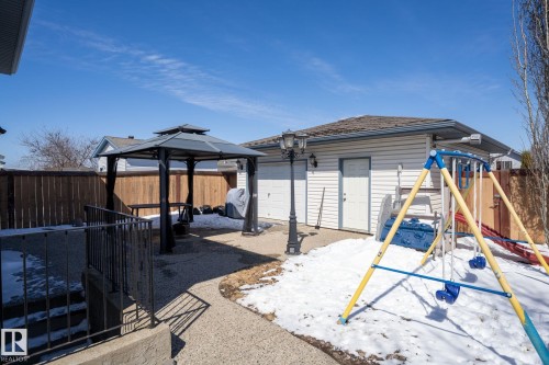 Detached garage with two white garage doors and a separate entry door - 1904 36 Avenue, Edmonton, AB - Outdoor