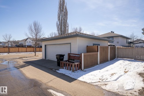 Detached garage with white siding, a single overhead door, and an asphalt shingle roof - 1904 36 Avenue, Edmonton, AB - Outdoor