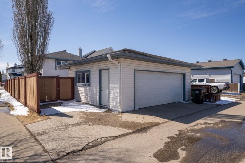 Detached garage with white siding, a single overhead door, and a side access door - 1904 36 Avenue, Edmonton, AB - Outdoor With Exterior