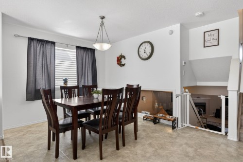 Dining area with durable tile flooring and a window featuring horizontal blinds - 1904 36 Avenue, Edmonton, AB - Indoor Photo Showing Dining Room