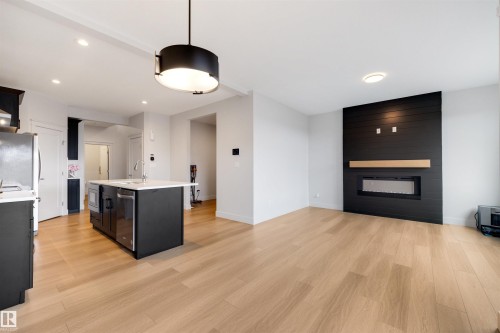Open-concept living space with light wood-finish flooring - 3193 Checknita Way, Edmonton, AB - Indoor