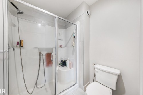 Shower enclosure featuring clear glass panels and a white base - 3193 Checknita Way, Edmonton, AB - Indoor Photo Showing Bathroom