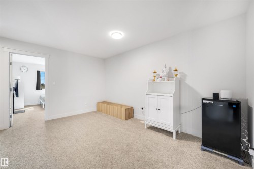 Carpeted interior space with white walls and baseboards - 3193 Checknita Way, Edmonton, AB - Indoor