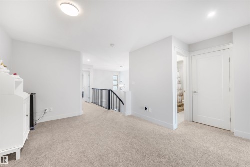 Carpeted upper level landing with white walls and trim - 3193 Checknita Way, Edmonton, AB - Indoor Photo Showing Other Room