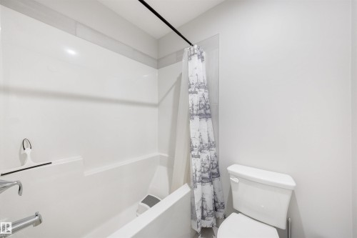 White bathtub and shower combination with chrome fixtures - 3193 Checknita Way, Edmonton, AB - Indoor Photo Showing Bathroom
