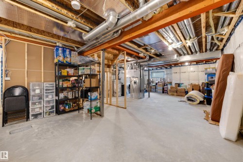 Unfinished lower level featuring exposed ceiling joists, concrete flooring, and ample open space - 3193 Checknita Way, Edmonton, AB - Indoor Photo Showing Basement