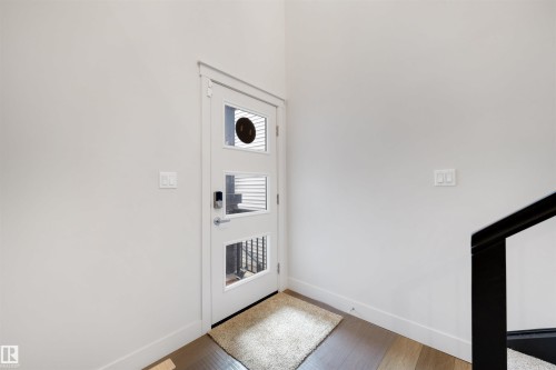 Entryway featuring a contemporary white door with three rectangular glass inserts and a smart lock - 3193 Checknita Way, Edmonton, AB - Indoor Photo Showing Other Room