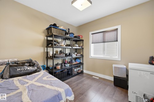 This room features light tan walls, a single window with blinds, and durable wood-look flooring - 2018 Armitage Green, Edmonton, AB - Indoor Photo Showing Bedroom