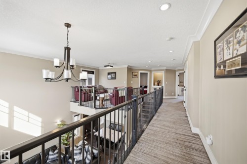 The property features an open-concept design with a hallway overlooking a living area - 2018 Armitage Green, Edmonton, AB - Indoor Photo Showing Other Room