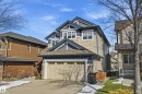 This property features a two-car garage, a paved driveway, and stone accents on the exterior - 2018 Armitage Green, Edmonton, AB  - Outdoor 