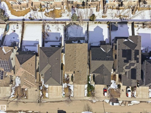 Aerial view of a residential street featuring properties with driveways, pitched roofs, and solar panels on some roofs - 2018 Armitage Green, Edmonton, AB - Other