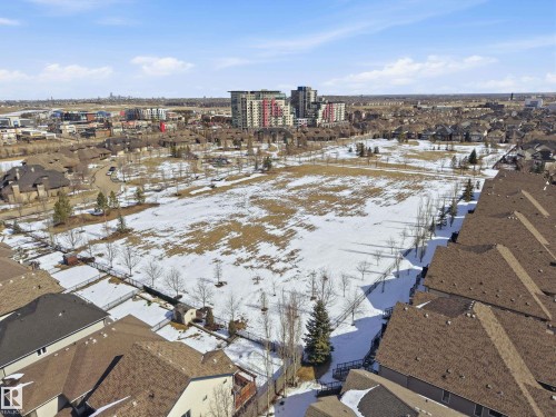 Aerial view showcasing a residential area with a large open field, surrounded by various properties with brown roofs - 2018 Armitage Green, Edmonton, AB - Outdoor With View