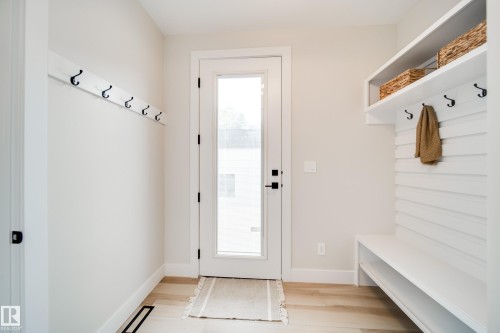 Entryway featuring light wood-finish flooring and a full-light exterior door with matte black hardware - 9625 101 Street, Edmonton, AB - Indoor Photo Showing Other Room