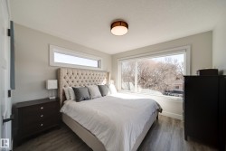 Spacious room featuring wood-finish flooring, light gray wall paint, and a white trim package - 