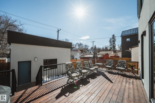 Spacious wood-finish deck featuring a black metal railing - 9625 101 Street, Edmonton, AB - Outdoor With Deck Patio Veranda With Exterior